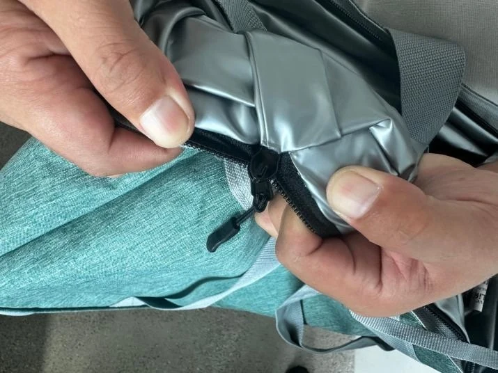 Close-up inspection of a cooler bag zipper end and lining